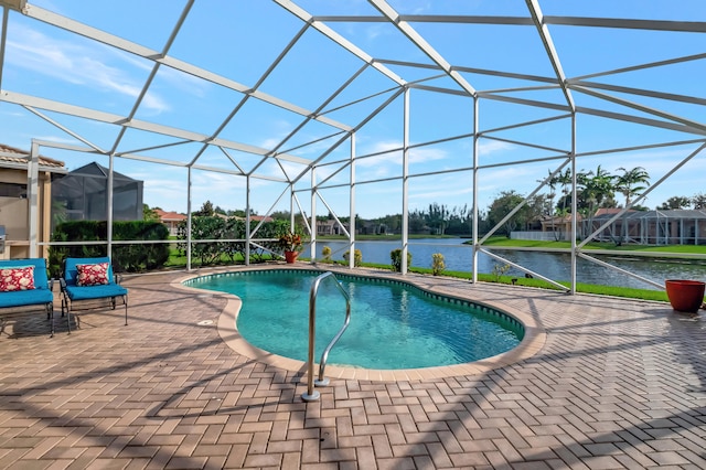 view of pool with a lanai, a patio area, and a water view