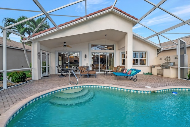 back of house with a lanai, area for grilling, ceiling fan, and a patio