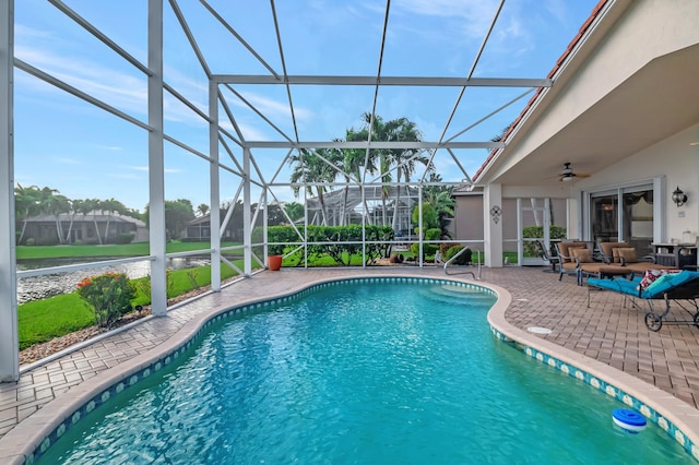 view of pool featuring glass enclosure and a patio