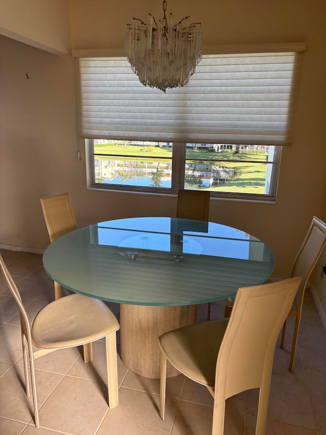 tiled dining area with a chandelier