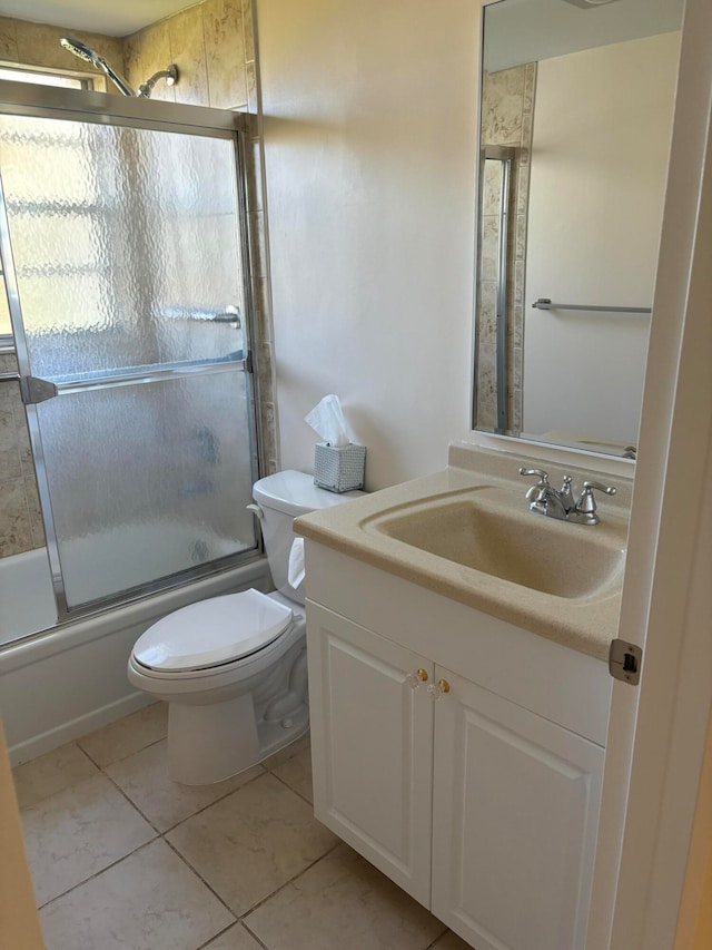 full bathroom with shower / bath combination with glass door, vanity, toilet, and tile patterned flooring