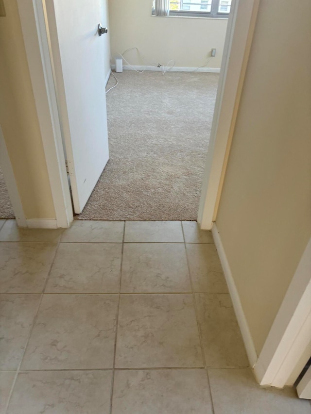 hallway with light colored carpet