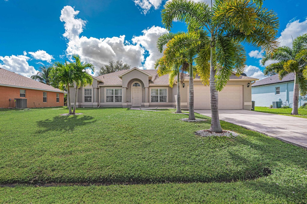 ranch-style house with a front lawn, cooling unit, and a garage