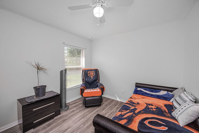 bedroom with ceiling fan and hardwood / wood-style flooring