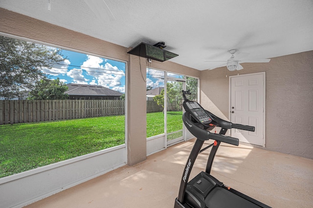 workout room featuring ceiling fan and plenty of natural light