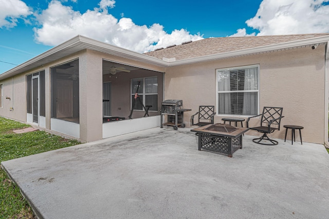 back of house featuring a patio area, a sunroom, and an outdoor fire pit