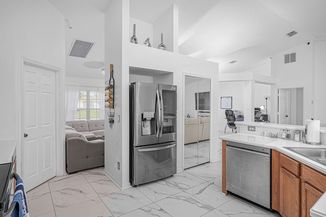 kitchen with high vaulted ceiling, sink, and stainless steel appliances