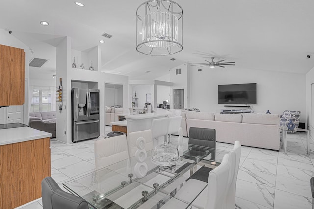 dining room featuring vaulted ceiling and ceiling fan with notable chandelier