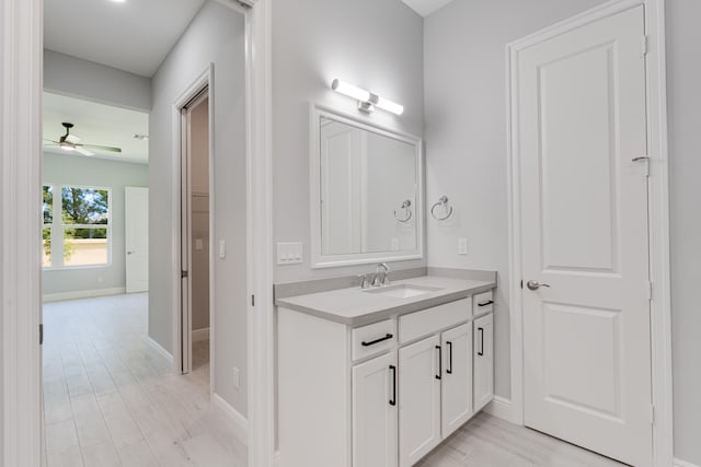 bathroom featuring vanity, hardwood / wood-style floors, and ceiling fan