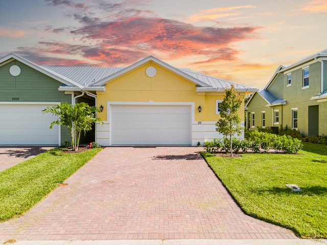 ranch-style home with a lawn and a garage