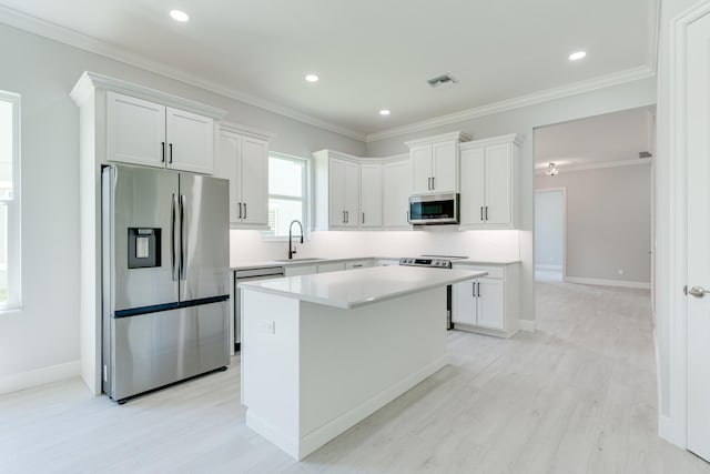 kitchen featuring white cabinets, appliances with stainless steel finishes, and a center island