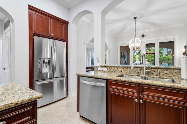 kitchen with sink, light stone counters, appliances with stainless steel finishes, light tile patterned flooring, and ornamental molding