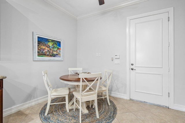 dining space featuring ceiling fan, light tile patterned flooring, and ornamental molding