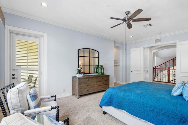 carpeted bedroom featuring ceiling fan and crown molding