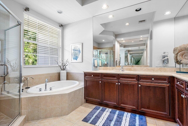 bathroom with tile patterned flooring, vanity, and separate shower and tub