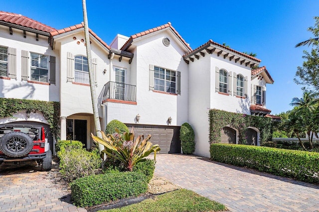 mediterranean / spanish-style house featuring a garage