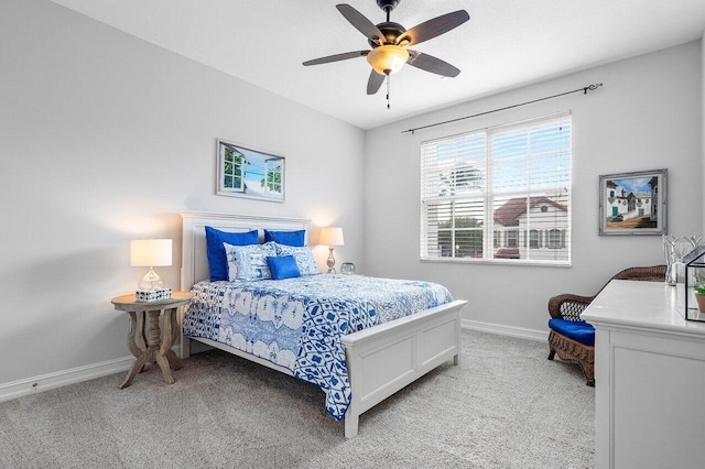 bedroom featuring ceiling fan and light carpet