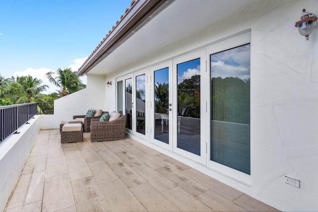 view of patio with a balcony and french doors