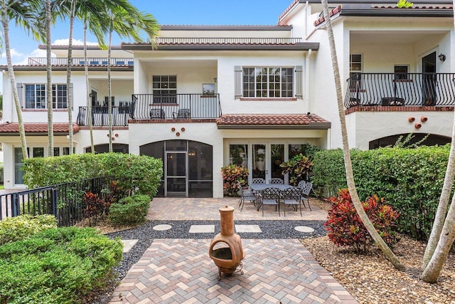 rear view of property with french doors and a patio