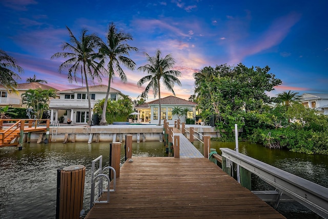 dock area featuring a balcony and a water view