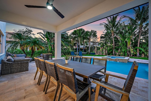 patio terrace at dusk with ceiling fan and a pool with hot tub