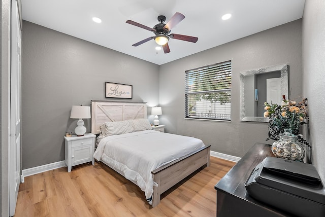 bedroom featuring light wood finished floors, recessed lighting, ceiling fan, and baseboards