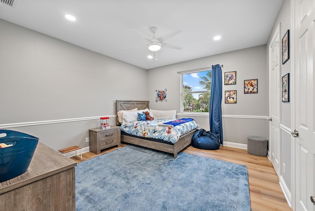 bedroom with recessed lighting, ceiling fan, visible vents, baseboards, and wood finished floors