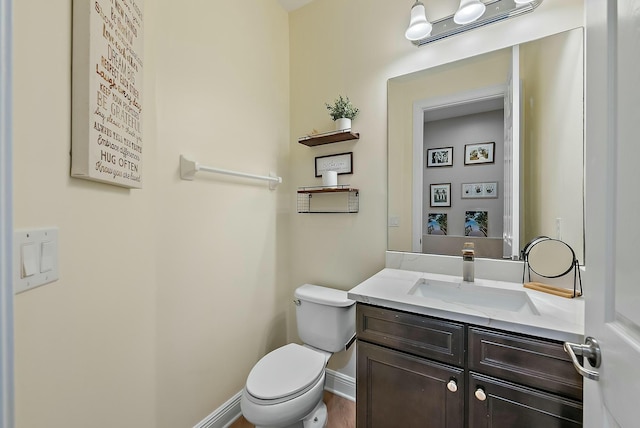 bathroom with toilet and vanity