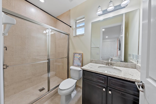 full bath featuring toilet, tile patterned floors, a shower stall, and vanity