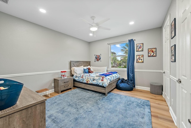 bedroom with ceiling fan and hardwood / wood-style floors