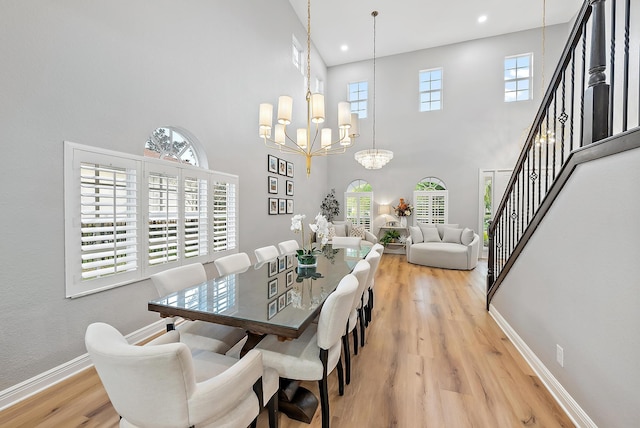 dining space featuring an inviting chandelier, a high ceiling, and a wealth of natural light