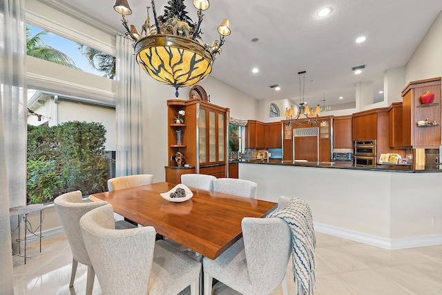 kitchen featuring brown cabinets, stainless steel double oven, light wood-type flooring, black electric cooktop, and a kitchen island