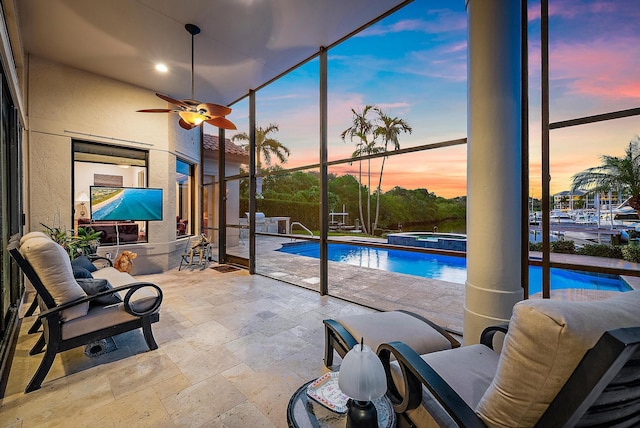 pool at dusk with a pool with connected hot tub, a patio, and fence
