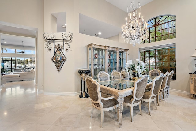 living room featuring a notable chandelier, a towering ceiling, and recessed lighting