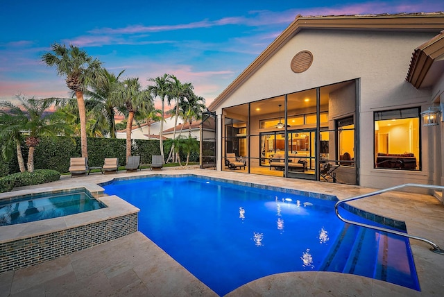 rear view of property featuring an outdoor pool, a water view, boat lift, a patio, and an in ground hot tub
