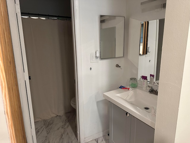 bathroom with toilet, sink, and curtained shower