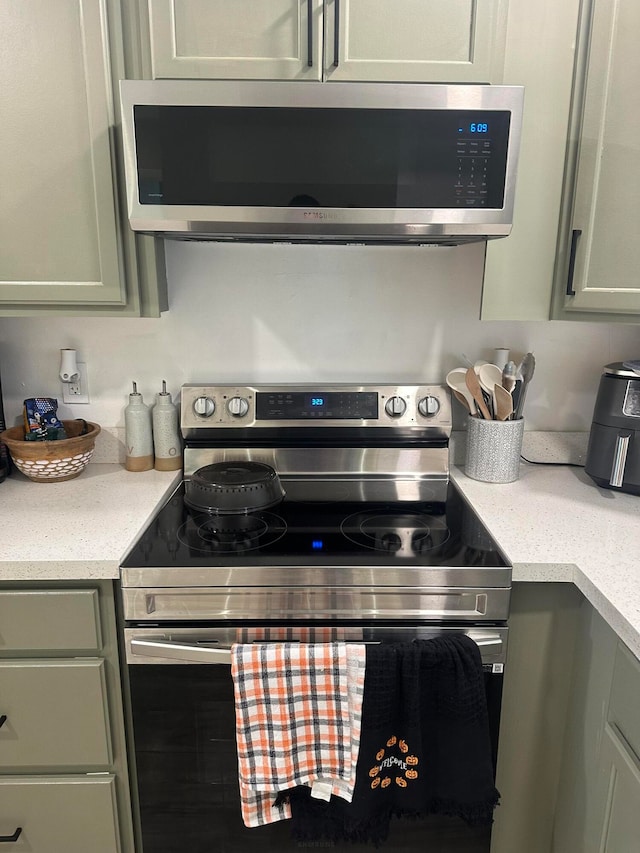 kitchen featuring green cabinetry and stainless steel appliances