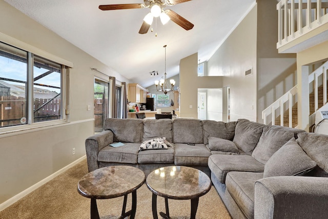 living room with ceiling fan with notable chandelier, high vaulted ceiling, and carpet floors