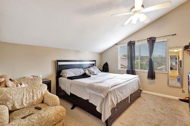 carpeted bedroom featuring ceiling fan, a textured ceiling, and lofted ceiling