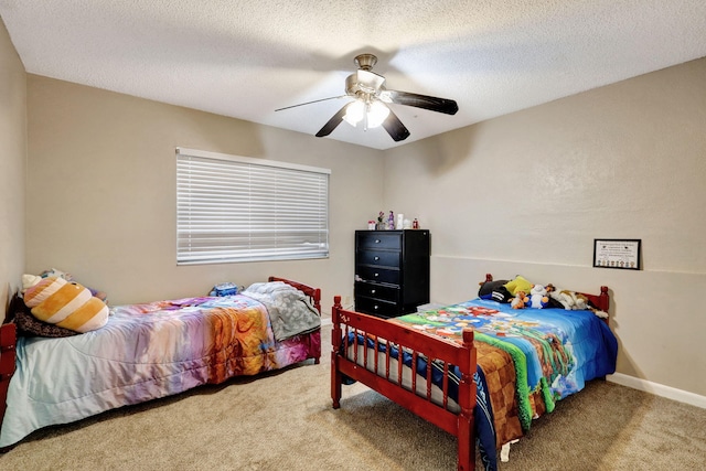 carpeted bedroom featuring ceiling fan and a textured ceiling