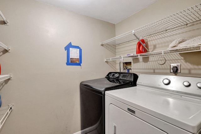 washroom featuring washer and clothes dryer