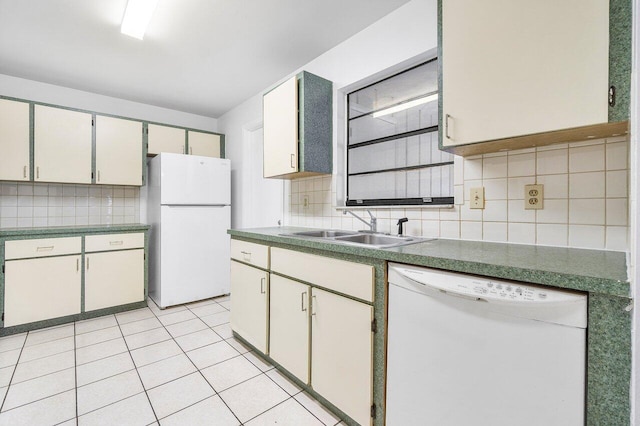 kitchen featuring light tile patterned floors, decorative backsplash, sink, white cabinets, and white appliances