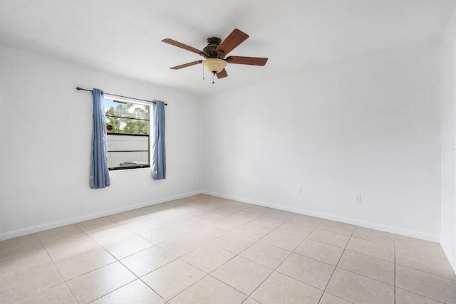 tiled empty room featuring ceiling fan