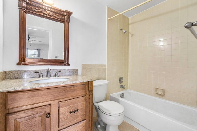 full bathroom with vanity, tiled shower / bath combo, and toilet