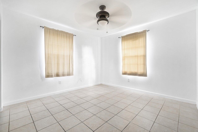 tiled empty room with ceiling fan