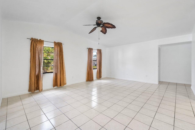 empty room with light tile patterned flooring, ceiling fan, and lofted ceiling