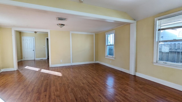 empty room featuring dark hardwood / wood-style floors and lofted ceiling