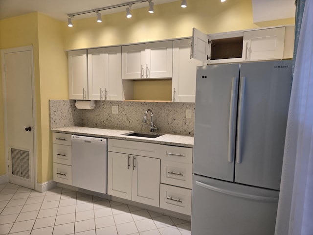 kitchen with open shelves, visible vents, freestanding refrigerator, white cabinets, and white dishwasher