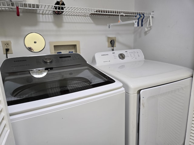 washroom with laundry area and washer and dryer