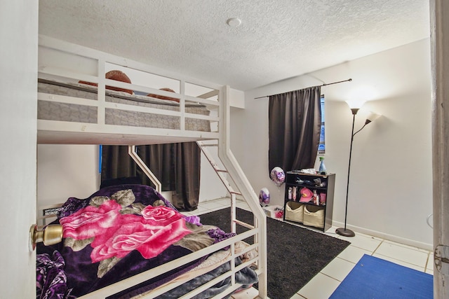 1801 SW Beeker St S, Port Saint Lucie, FL 34953 - tiled bedroom with a textured ceiling and baseboards